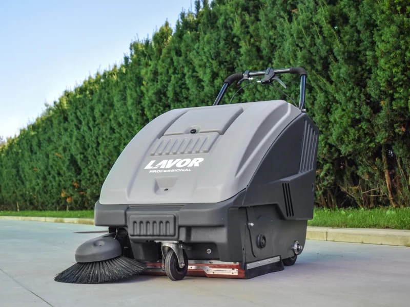 Lavor walk-behind sweeper collecting debris outdoors