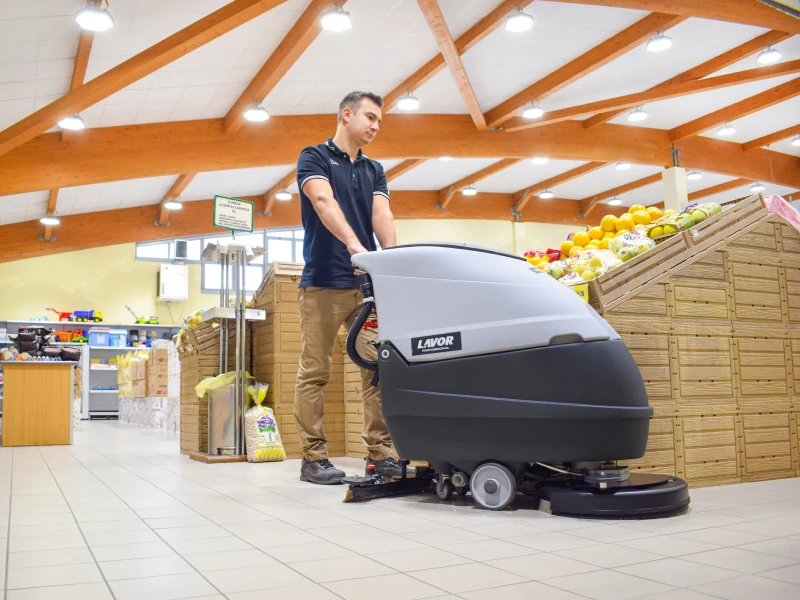 Lavor walk-behind scrubber-dryer cleaning a commercial floor